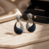 Elegant blue and grey marble drop earrings with gold accents for sophisticated style.